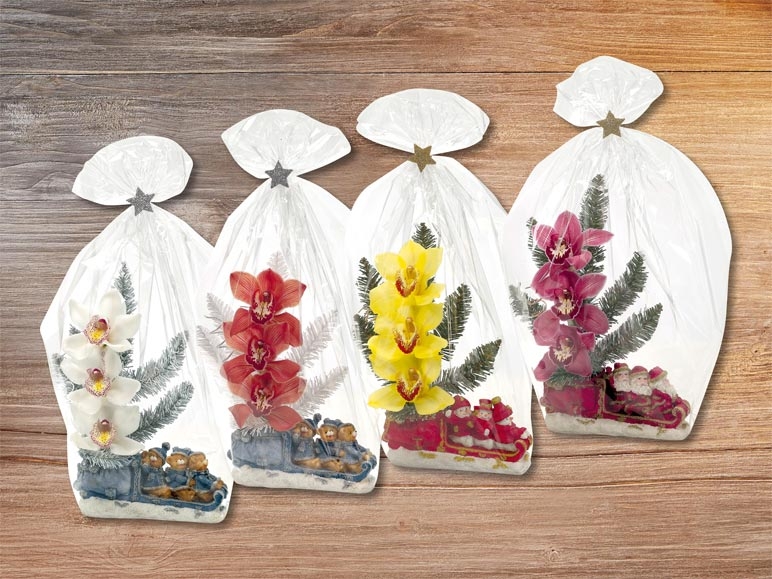 Compositions florales de 3 fleurs d'orchidées dans ne figurine de Noël (dés 17.12)