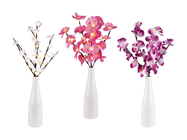 Branche lumineuse à LED dans un vase décoratif