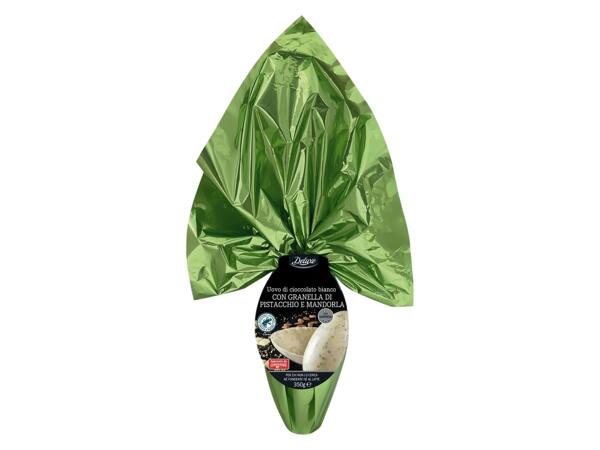 White chocolate egg with almonds and pistachios